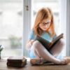 Bitney Adventures - Child with Glasses Reading - Pexels