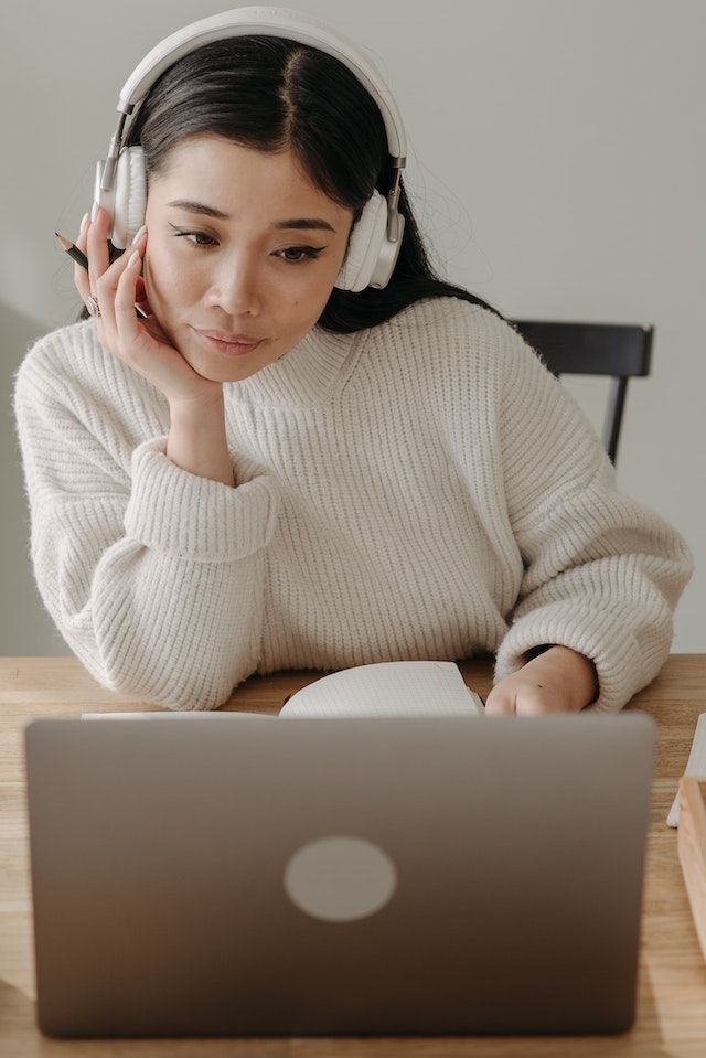 Bitney Adventures - Holy Spirit Music - Woman Listening to Music at a Desk on Wireless Headphones - Pexels