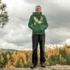 Man Standing in Forest Wearing Hoodie - Green