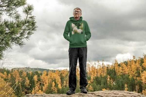 Man Standing in Forest Wearing Hoodie - Green