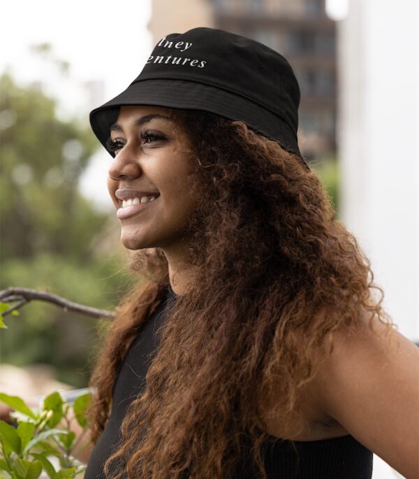 Bitney Adventures Bucket Hat - Woman Standing Outside by Plant Wearing Bucket Hat - Black